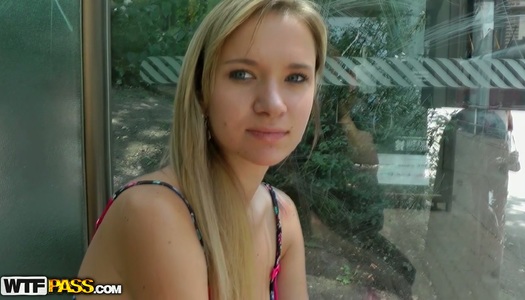 Blonde girl is chilling with guys in a park smoking a cigarette porn pics