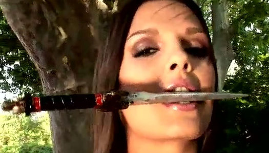 Risk-addicted brunette babe strokes her pussy with knife porn pics