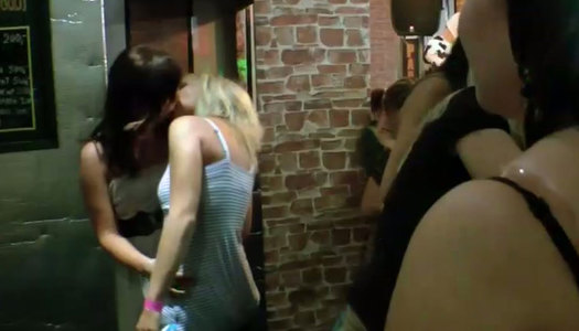 Sassy bitches are kissing passionately in a club porn pics