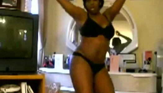 Frisky black hoe strips in front of cam in steamy black lingerie porn pics