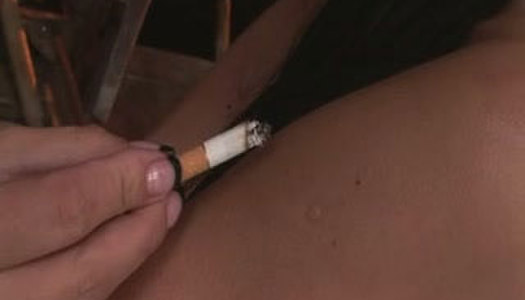 Tied up brunette bitch is smoking cigarette. BDSM porn action porn pics