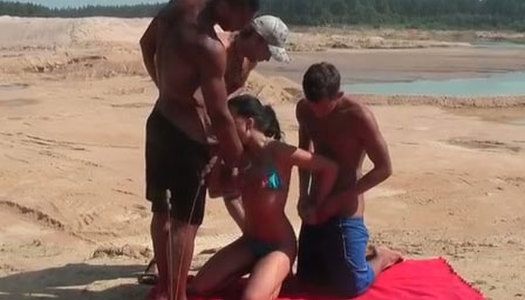 Kinky Russian chick is nailed doggy while sucking meaty cock on a beach porn pics