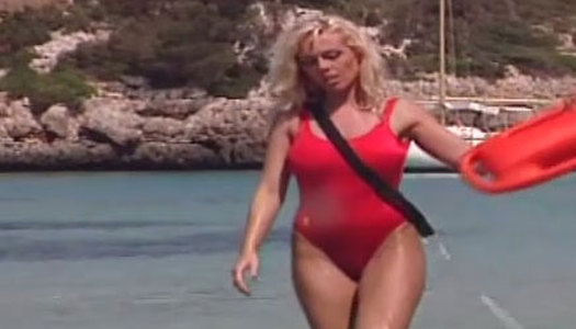 Saucy blond haired MILF in red swim suit performs steamy solo on sandy beach porn pics