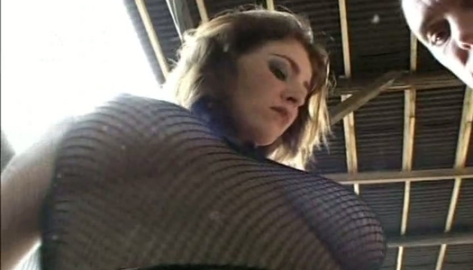 Amazing brunette in fishnet top gets pussy fucked by hunks on the table porn pics