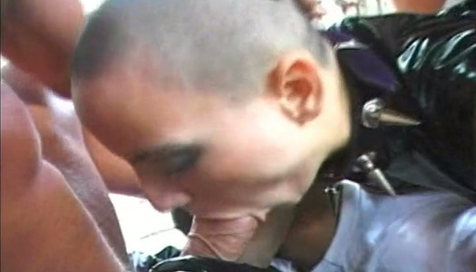 Bald headed latex bitch takes DP while purple haired nympho sucks dicks porn pics