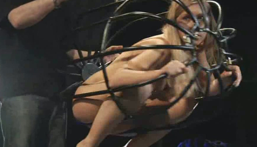 Cute blonde in the cage is punished by perverted master porn pics
