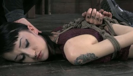 Brunette chick is lying on the floor with tied up hands porn pics