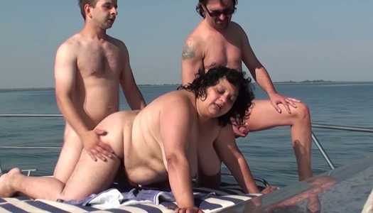 Two perverted dudes fuck ugly plumper on the yacht porn pics