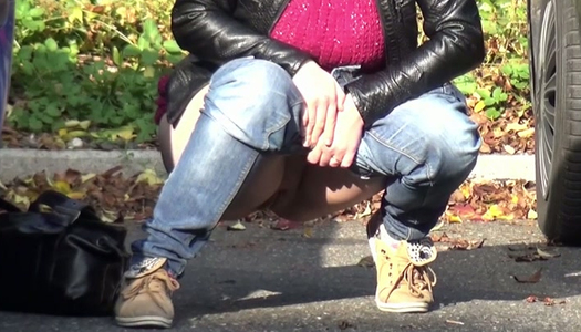 Raven haired filthy gal makes pees between two cars outdoors porn pics