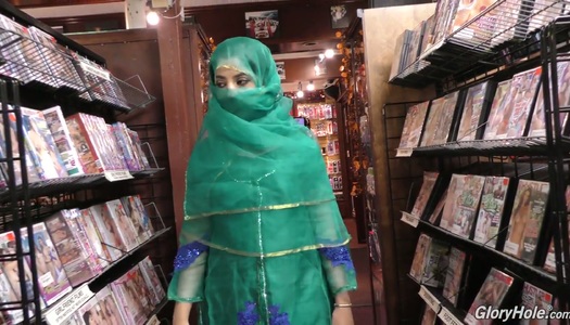 Hot Pakistani chick Nadia Ali sucks big dick in the glory hole room porn pics