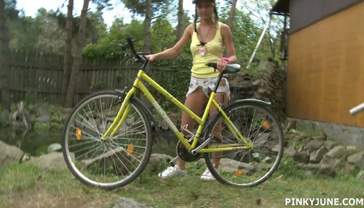 Young blonde is riding her bicycle and masturbating pussy outdoor porn pics
