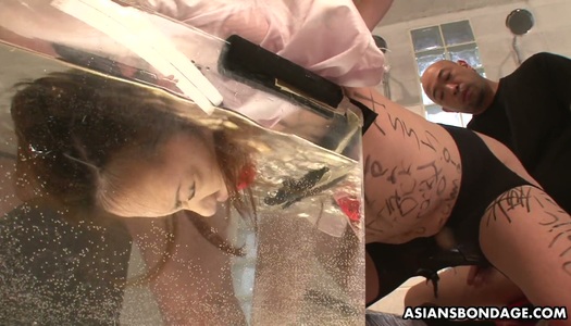 Two Asian dudes fuck pussy of tied up chick with a ball gag in mouth porn pics