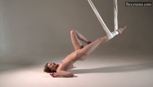 Flexible Russian gymnast Sofia Zhiraf gets naked in the aerial hammock porn pics